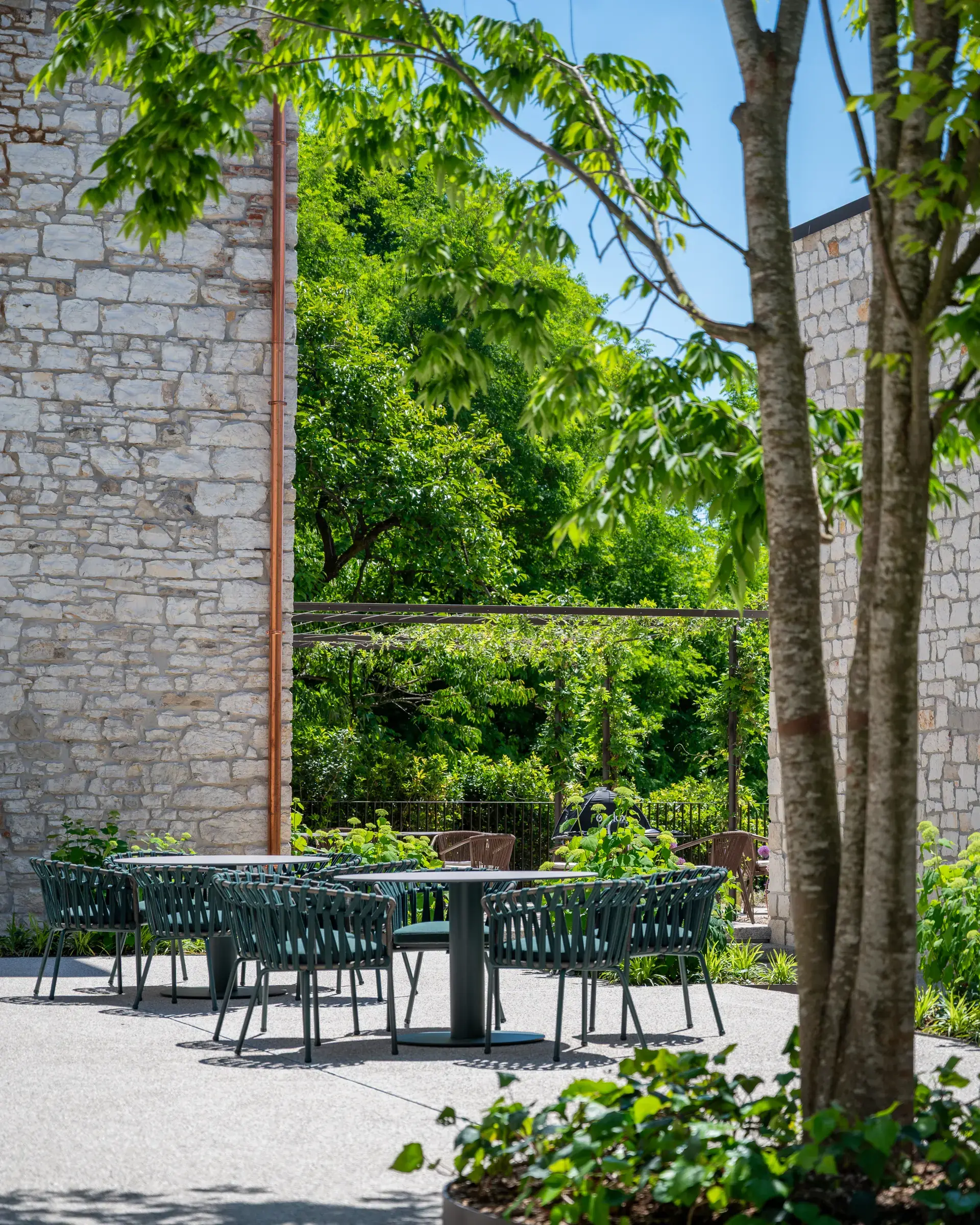 Suite Autobiography — private garden as an open-air sitting room surrounded by greenery at Borgo Taurino
