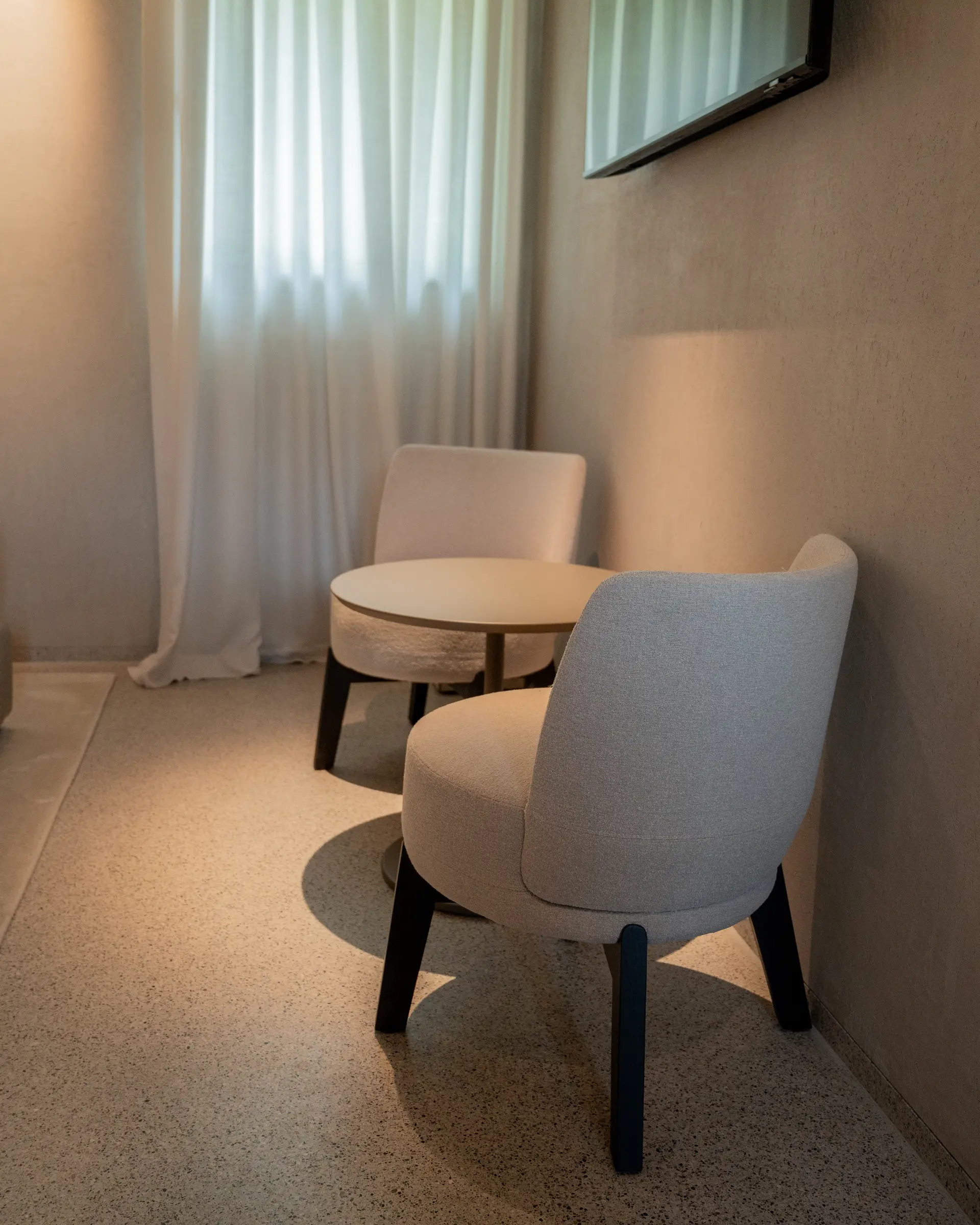 Deluxe Room — lounge corner with light curtains and filtered natural light at Borgo Taurino
