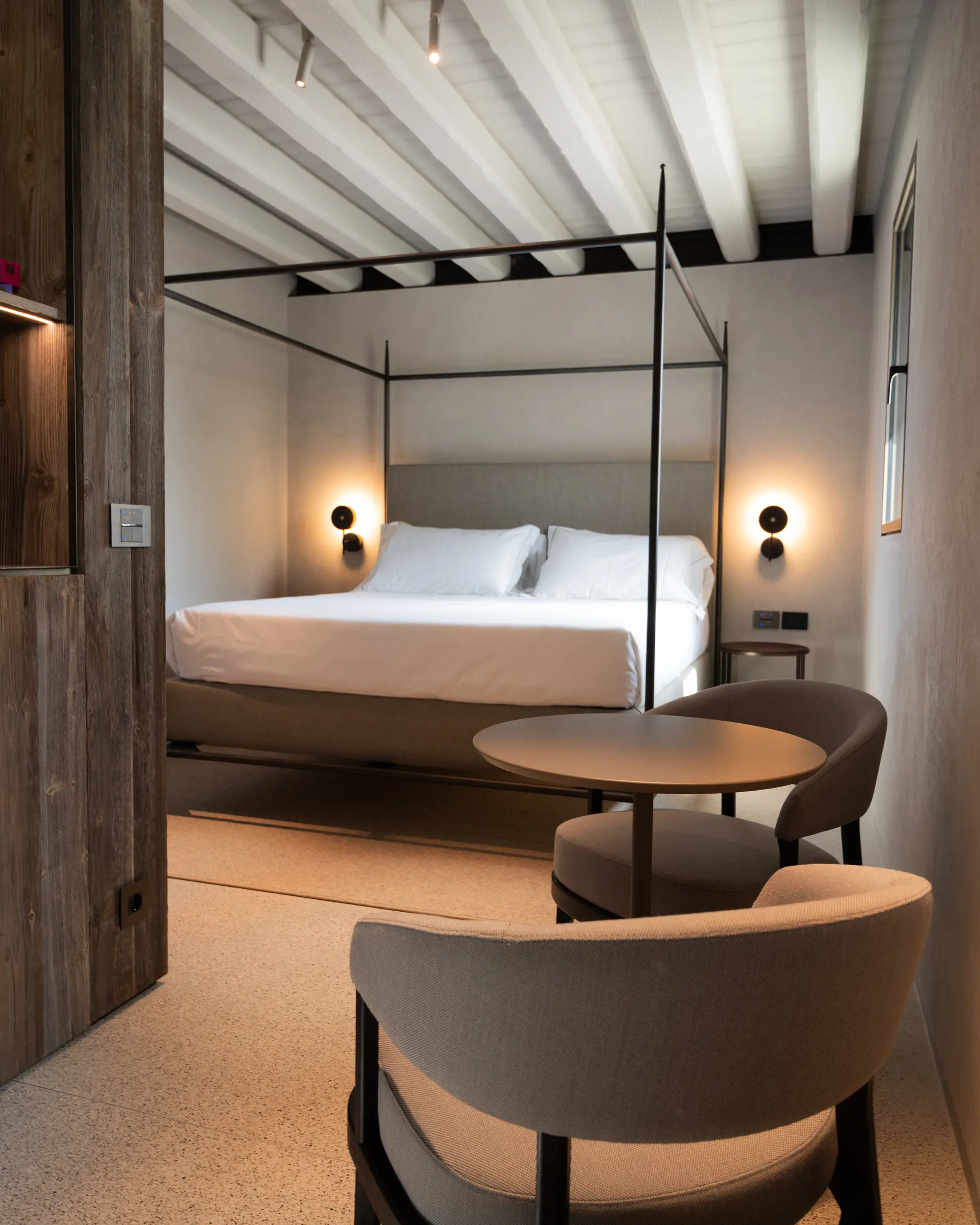 Junior Suite at Borgo Taurino — king bed with brushed-iron canopy
