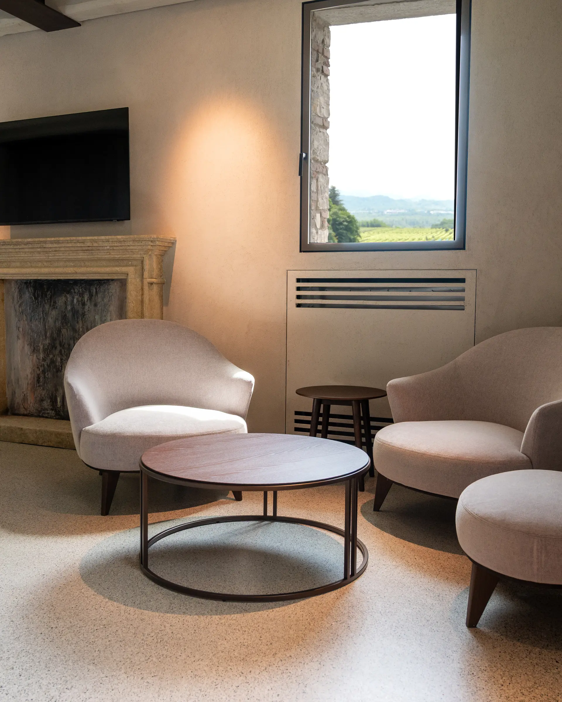 Suite at Borgo Taurino — separate living with antique stone fireplace and UNESCO vineyard view